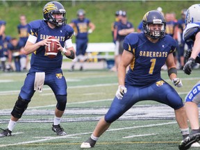 PETER RUICCI/Sault Star
With running back Greg Caruso offering protection, Sault Sabercats varsity quarterback Jordan Robinson-Wright (left) looks for a target in 2018 Ontario Football Conference action. It looks as if the Cats will miss their second consecutive OFC season