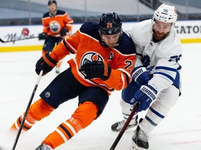 Edmonton Oilers’ Leon Draisaitl (29) battles Toronto Maple Leafs’ TJ Brodie (78) during third period NHL action at Rogers Place in Edmonton on Wednesday, March 3, 2021. Photo by Ian Kucerak