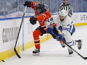 Toronto Maple Leafs defenceman T.J. Brodie (78) and Edmonton Oilers forward Leon Draisaitl (29) play for the puck during the third period at Rogers Place in Edmonton on March 1, 2021. (Perry Nelson-USA TODAY Sports)