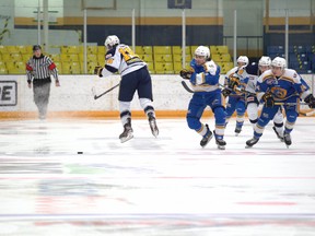 The Fort McMurray Oil Barons take the puck around the Spruce Grove Saints during their game at the Centerfire Place on Friday, March 26, 2021. Photo by Dan Lines