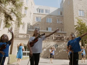 Members of Kingston Canta Arya School for Strings perform for residents in the courtyard of Providence Manor in the new documentary "Resonance: Music Across the Ages."