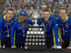 Team Alberta under (L-R) skip Brendan Bottcher, 3rd Darren Moulding, 2nd Brad Thiessen and lead Karrick Martin with their trophy after defeating Team Wild Card 2, 4-2 to capture the Brier March 14 at WinSport Arena in Calgary. MICHAEL BURNS/Curling Canada