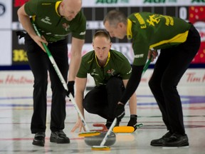 Team Northern Ontario skip Brad Jacobs (centre) follows his front end of second E.J. Harnden (right) and lead Ryan Harnden during Draw 8 against New Brunswick. Curling Canada/ Michael Burns Photo