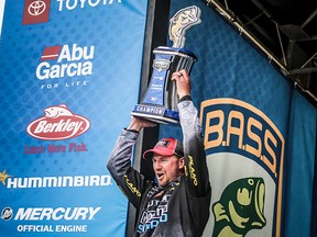 Jeff Gustafson hoists the Bassmaster Elite Series trophy above his head on Sunday, Feb. 28. The Keewatin product caught 66 pounds over four days to win the tournament on the Tennessee River.