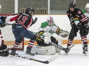 Amherstview Jets goaltender Jacob Evans makes a pad save with Gananoque Islanders Ryan Bigler (13) and Riley Twofoot (6) buzzing around the net in a Provincial Junior Hockey League game in Amherstview on Sept. 15, 2018. The Islanders have folded and are for sale.