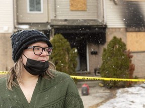 Amberlee Hill and her family live next door to a unit on Bonaventure Drive in London that was destroyed by fire Saturday. Hill said Monday March 1, 2021, that she lost all her possessions and those of her three children in the fire, and the family didn't have insurance. Three units will need to be gutted, said restoration workers on scene. The Office of the Ontario Fire Marshal and London police are investigating the suspicious fire. (Mike Hensen/The London Free Press)