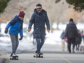 Marvin Rivas of London, who owns the Che Restaurant on Dundas Street, took Sunday morning off to go skateboarding with his son Alexander, 10, in Springbank Park in London. (Mike Hensen/The London Free Press)