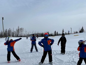 The Fort McMurray Ski Club Snow Stars 1 group do some warm-ups at the hill. Supplied image/Kathi Brewer-Guthro