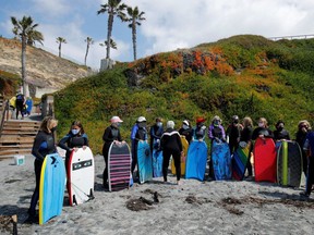 A senior women's group gather for a morning boogie boarding session in the ocean waves on International Women's Day, amid the outbreak of the coronavirus disease (COVID-19) in Solana Beach, California, U.S., March 8, 2021. REUTERS/Mike Blake ORG XMIT: FW1