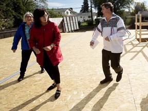 Indigenous Relations Minister Rick Wilson, right, dances a Métis jig with Seniors and Housing Minister Josephine Pon, centre, and Métis Nation of Alberta President Audrey Poitras, left, during a tour of a Métis Capital Housing Corporation affordable housing project at 13027 133 St., in Edmonton Wednesday Sept. 2, 2020. Photo by David Bloom