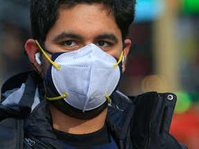 File: Double masking has been suggested as one way to prevent infection from the new COVID-19 variants