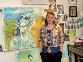 Dawn Saunders Dahl stands by a self portrait in her studio in Elk Run in Canmore. photo by Pam Doyle/www.pamdoylephoto.com