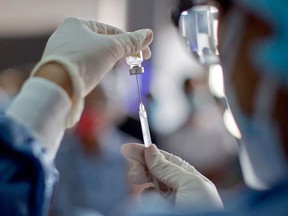 A health worker prepares a dose of COVID-19 vaccine. Photo by ERIKA SANTELICES/AFP via Getty Images