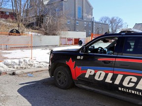 A police vehicle idles next to the former Hotel Quinte property Tuesday. Police said a body was found early that morning near the property's rear wall.
