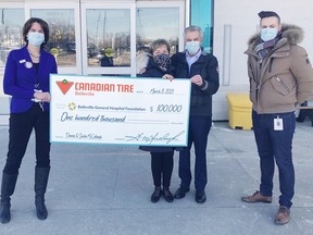 QHC President and CEO Stacey Daub (left) and BGHF Executive Director Steve Cook (right) accept a cheque for $100,000 from Sheila and Dennis McCullough from Canadian Tire Belleville for BGHF's "Be Well" campaign. SUBMITTED PHOTO