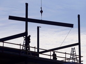 Workers atop a building under construction along Dundas Street West in Belleville Tuesday affix steel beams. A new report by ManpowerGroup Canada predicts 17 per cent of Belleville employers plan to hire in the next quarter, while growth of five per cent is expected in the national construction job market.