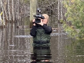 Loyalist College graduate Morganne Campbell, now a digital broadcast journalist with Global News, wades through water to report on the impacts of climate change in Atlantic Canada. Campbell said the faculty at Loyalist encouraged her to develop an expansive skill set to make her more valuable to any potential employer. SUBMITTED PHOTO