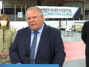 Premier Doug Ford speaks Tuesday during an online news conference. Listening were Health Minister Christine Elliott and vaccine task force chair Gen. (Ret.) Rick Hillier, whose final day with the group is Wednesday.