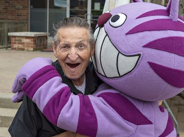 Walter Gretzky gets a hug from Smile City Kitty, the mascot of the Paris Dental Centre on Saturday June 9, 2018 at Find Your Spirit, the tenth anniversary celebration of Harmony Square in downtown Brantford, Ontario. Brian Thompson/Brantford Expositor/Postmedia Network