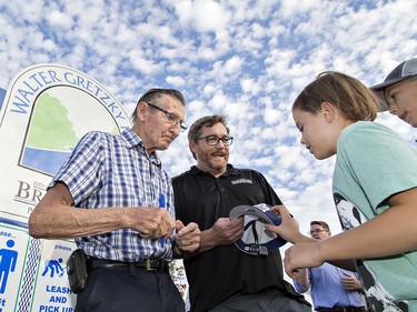 Walter Gretzky was on hand Wednesday afternoon October 10, 2018 for the official opening of a new park named after him behind St. Basil/Walter Gretzky School in Brantford, Ontario. Here, Brantford mayor Chris Friel returns a ball cap signed by Canada's greatest hockey dad for ten-year-old Caleb Brito. Brian Thompson/Brantford Expositor/Postmedia Network