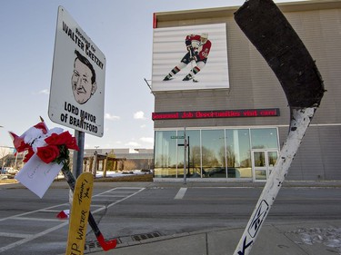 Hockey sticks and floral tributes are placed by Walter Gretzky's reserved parking spot at the Wayne Gretzky Sports Centre in Brantford, Ontario on Friday March 5, 2021. Canada's favourite hockey dad passed away at his Brantford home at the age of 82. Brian Thompson/Brantford Expositor/Postmedia Network