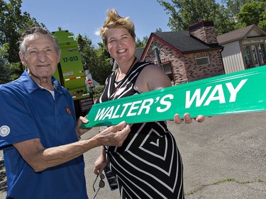 Children's Safety Village executive director Lisa Young shows Walter Gretzky the street sign which will be mounted on one of the streets in the village on Saturday June 24, 2017 in Brantford, Ontario.  Brian Thompson/Brantford Expositor/Postmedia Network