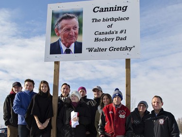 Walter Gretzky (red jacket) is joined by family members (from left) Zach Kohler, Glen Gretzky, Mila Gretzky, Brent Gretzky, Blandford-Blenheim mayor Marion Wearn, Nathan and Austin Kohler, Avery Gretzky, Kim and Ian Kohler following the unveiling of a sign denoting his birthplace on Saturday December 10, 2016 in the village of Canning, west of Brantford, Ontario. Brian Thompson/Brantford Expositor/Postmedia Network