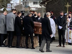 Wayne Gretzky watches as the casket containing his father, Walter, is loaded into the back of a hearse after his funeral at St. Mark's Anglican Church  on Saturday. Michelle Ruby