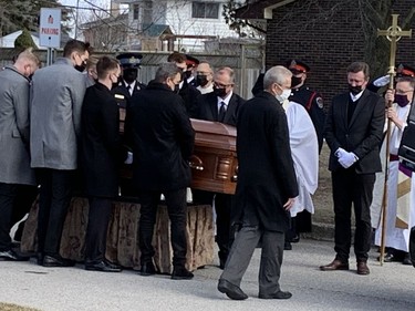 Hockey legend Wayne Gretzky (right) watches as his father Walter's casket is carried from St. Mark's Anglican Church in Brantford during a funeral service on Saturday.