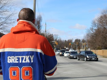 Dave Szczur of Brantford, who watches the approaching funeral procession for Walter Gretzky, was among a couple of hundred people who lined to street outside St. Mark's Anglican Church on Saturday, March 6 to pay tribute the world's most famous hockey dad. MICHELLE RUBY/BRANTFORD EXPOSITOR