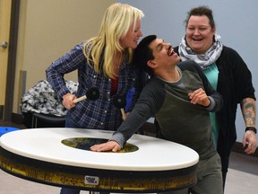 Daniel Vecchiato feels the vibrations of the table drum played by music therapist Amy Di Nino (left) at Sensity. Working with Vecchiato during a music therapy session is his intervenor, Tina Wood.