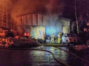 County of Brant firefighters battle a blaze in one of three buildings at a Muir Road address in Brant County on March 10, 2021.