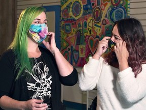 Leanne Zyba and Nikki Campbell Schram from Art With Heart Studio in Simcoe wear masks as they stand in front of Colourful Art from Episode 4-2 of Windecker Road Films production of Making Things Count: Pandemic Postcards. The show will be among titles available for free streaming during Watch Local Week April 18-24 via the Haldimand and Norfolk County Public Library websites. SUBMITTED PHOTO