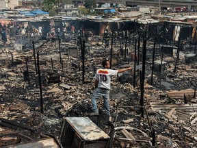 Inhabitants of a favela in the east area of Sao Paulo, Brazil, are seen amid the debris of their belongings after a fire in August, 2012.