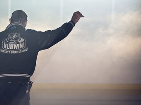 Walter Gretzky waves to the crowd as he is introduced as the honorary coach of the NHL Alumni team at the Wayne Gretzky Sports Centre in Brantford.