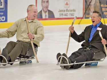 Former NHLer Jay Wells (left) of Paris chuckles with Walter Gretzky as they try out sledge hockey sleds in 2011 at the Brant Sports Complex.