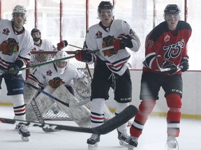 The Braves and 73's watch the puck from around the Brockville net during an outdoor scrimmage at Rotary Park on Sunday afternoon. The event hosted by the Jr. A Braves was a fundraiser for the Brockville and Area Food Bank.
Tim Ruhnke/The Recorder and Times