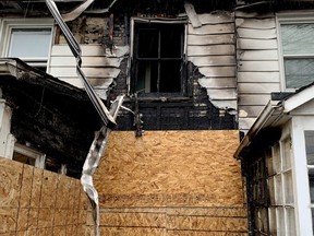 A row of houses on Buell Street hit by fire overnight Wednesday to Thursday was boarded up and fenced off by Friday morning. (RONALD ZAJAC/The Recorder and Times)