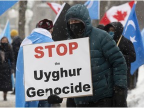 Protesters gather outside the Parliament buildings in Ottawa on Feb. 22 as the opposition presented a motion calling on Canada to recognize China's actions against ethnic Muslim Uighurs as genocide.