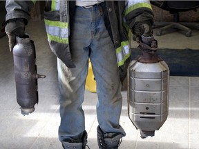 A local auto wrecker employee displays two of the many type of catalytic converters that thieves have been targeting in the area. (Ellwood Shreve/Chatham Daily News)