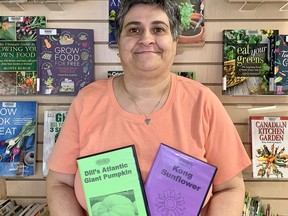 Deb Ready, a library assistant, displays the giant pumpkin and sunflower seeds that will be available at all 11 Chatham-Kent Public Library branches when the fifth season of the popular seed library is launched on Saturday.