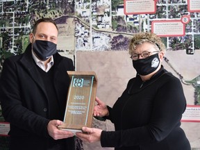 Sean Dyke, CEO of the St. Thomas Economic Development Corporation presents Jan Hawley, the economic development officer for the Municipality of Huron East, with an award from the Economic Development Council of Ontario for The Downtown Seaforth's Back Alley Initiative – Looking Out My Back Door. Dan Rolph