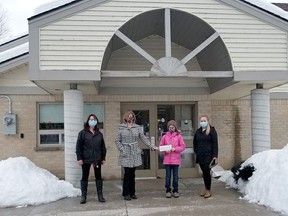 Standing outside the Huron Women's Shelter, 11-year-old Leah Boven donates a portion of the funds she raised selling 500 ml bottles of BBQ Sauce and Maple Syrup. Boven ended up donating $750 to the food bank and another $750 to Huron Women's Shelter Second Stage Housing facility in Clinton. Handout