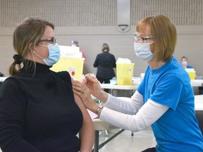 Veronica Kolkman demonstrates how the COVID-19 vaccine is administered to a patient. Dan Rolph