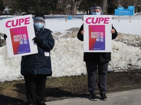 Dietary aids Rose-Marie Touchette (left) and Sherry Renaud during a short, midday protest at  Heartwood Long-Term Care Home. Photo on Monday, March 8, in Cornwall, Ont. Todd Hambleton/Cornwall Standard-Freeholder/Postmedia Network