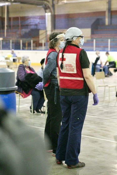 Canadian Red Cross volunteers stand ready at the Rockland vaccination facility on Friday, March 19, 2021 in Rockland, Ont. Jordan Haworth/Cornwall Standard-Freeholder/Postmedia Network