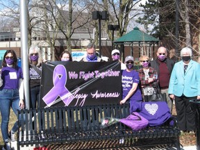 Coun. Elaine MacDonald (far right) joined Louise Blanchet and many family members near the Justice Building in Cornwall,  getting ready for Friday's Purple Day for epilepsy awareness, with the purple flag that will be hoisted. Photo on Thursday, March 25, 2021, in Cornwall, Ont. Todd Hambleton/Cornwall Standard-Freeholder/Postmedia Network