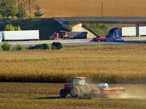 A farmer plants wheat near the 401. Photo Ken Wightman