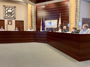 Cochrane town council at the beginning of their March 8 meeting, their first to be held back at the RancheHouse in months. Patrick Gibson/Cochrane Times