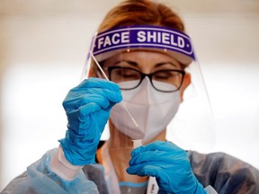 FILE: A health worker takes an antigen test.